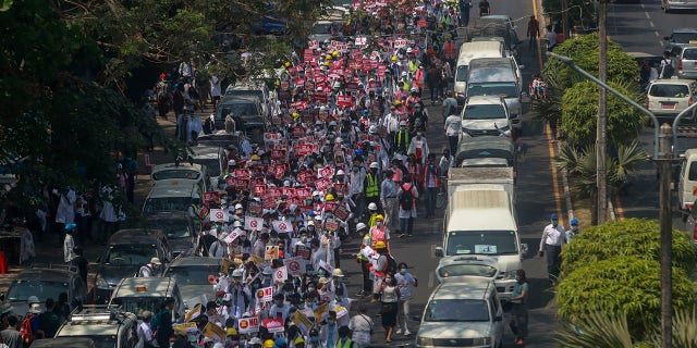 Anti-coup protesters march in Yangon, Burma, on Thursday. (AP Photo)