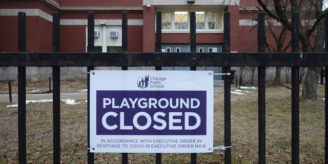 A sign outside of Columbus Elementary School lets visitors know that the playground has been closed on January 25, 2021 in Chicago, Ill. Chicago Public School teachers were scheduled to return to the classroom for in-person learning today, but the union objected and voted to continue remote learning. (Photo by Scott Olson/Getty Images)
