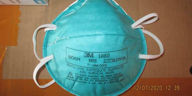 This December 2020 image provided by U.S. Immigration and Customs Enforcement (ICE) shows a counterfeit N95 surgical mask that was seized by ICE and U.S. Customs and Border Protection. Federal investigators are probing a massive counterfeit N95 mask operation sold in at least five states to hospitals, medical facilities, and government agencies and expect the number to rise significantly in coming weeks. The fake 3M masks are at best a copyright violations and at worst unsafe fakes that put unknowing health care workers at grave risk for coronavirus. And they are becoming increasingly difficult to spot. (ICE via AP)