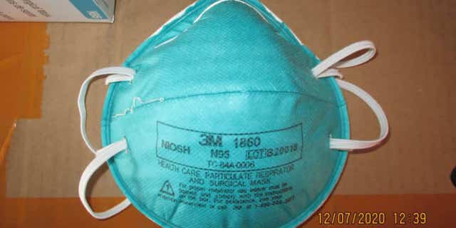 This December 2020 image provided by U.S. Immigration and Customs Enforcement (ICE) shows a counterfeit N95 surgical mask that was seized by ICE and U.S. Customs and Border Protection. Federal investigators are probing a massive counterfeit N95 mask operation sold in at least five states to hospitals, medical facilities, and government agencies and expect the number to rise significantly in coming weeks. The fake 3M masks are at best a copyright violations and at worst unsafe fakes that put unknowing health care workers at grave risk for coronavirus. And they are becoming increasingly difficult to spot. (ICE via AP)