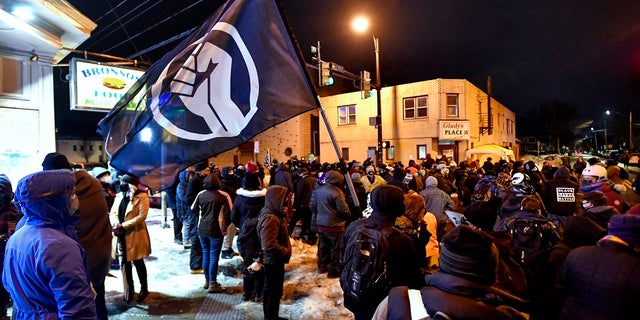 A crowd gathers near the site of Daniel Prude's encounter with police officers in 2020, in Rochester, N.Y., Tuesday, Feb. 23, 2021. (AP Photo/Adrian Kraus)