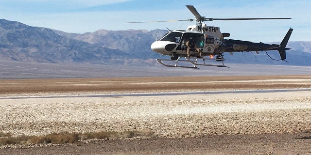 A California Highway Patrol helicopter is shown returning to the staging area after dropping off Inyo County search-and-rescue team members in Deimos Canyon. (NPS)