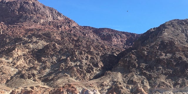 A helicopter from the California Highway Patrol approaches the accident site Saturday in Deimos Canyon. (NPS)