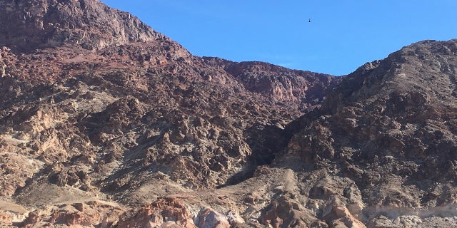 A helicopter from the California Highway Patrol approaches the accident site Saturday in Deimos Canyon. (NPS)