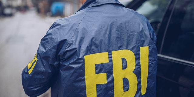 Male FBI agent seen in photo wearing FBI jacket