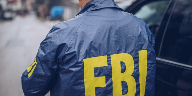 Male FBI agent seen in photo wearing FBI jacket