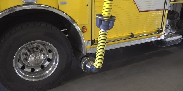 The Goodyear Fire Department has a bright yellow hose hooked up to their fire trucks exhaust, which will then redirect the harmful fumes up and out of the station.