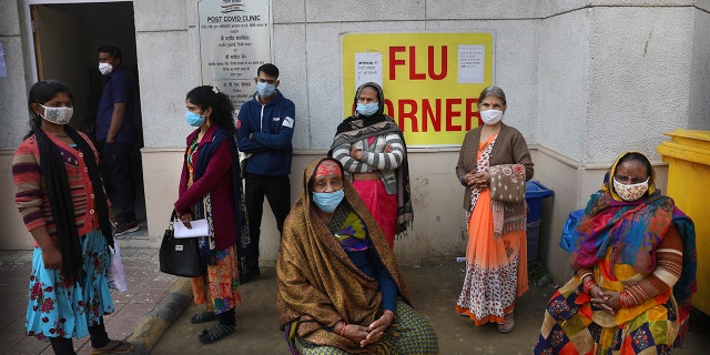 People wait outside a health center to get tested for COVID-19 in New Delhi, India, Thursday, Feb. 11, 2021. When the coronavirus pandemic took hold in India, there were fears it would sink the fragile health system of the world’s second-most populous country. Infections climbed dramatically for months and at one point India looked like it might overtake the United States as the country with the highest case toll. But infections began to plummet in September, and experts aren’t sure why. (AP Photo/Manish Swarup)