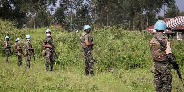 United Nations peacekeepers guard the area where a U.N. convoy was attacked and the Italian ambassador to Congo killed, in Nyiragongo, North Kivu province, Congo Monday, Feb. 22, 2021. (AP Photo/Justin Kabumba)