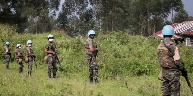 United Nations peacekeepers guard the area where a U.N. convoy was attacked and the Italian ambassador to Congo killed, in Nyiragongo, North Kivu province, Congo Monday, Feb. 22, 2021. (AP Photo/Justin Kabumba)