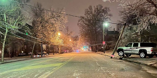 The Lexington Kentucky Police Department said Thursday that "crews were kept busy all night and early in the morning responding to numerous calls from icy limbs and power lines fallen on vehicles and roads." This image shows where a vehicle struck a pole, police said.