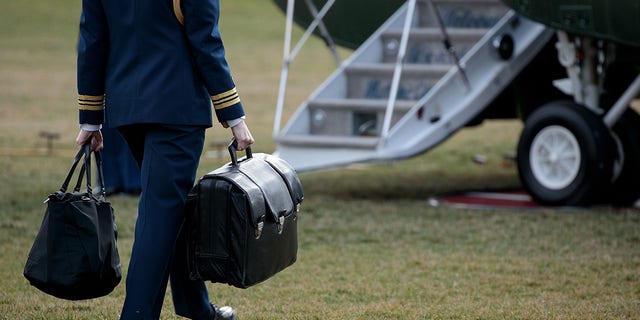 FILE - A military aide carries the alleged 'football,' a case with the launch codes for nuclear weapons, toward Marine One as former President Donald Trump prepares to take off. (Photo by Drew Angerer/Getty Images)