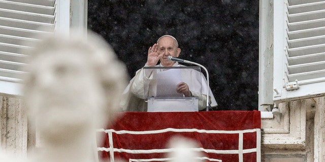 Pope Francis delivers his blessing from his studio window overlooking St. Peter's Square, at the Vatican, Sunday, Feb. 7, 2021. (AP Photo/Gregorio Borgia)