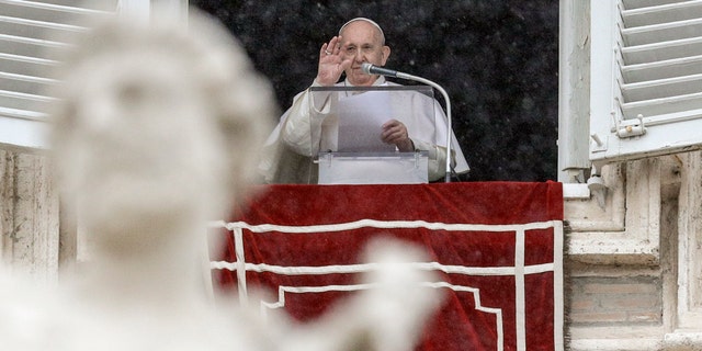 Pope Francis delivers his blessing from his studio window overlooking St. Peter's Square, at the Vatican, Sunday, Feb. 7, 2021. (AP Photo/Gregorio Borgia)