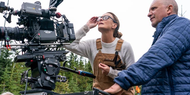 This image released by Focus Features shows actor-director Robin Wright, left, and director of photography Bobby Bukowski on the set of 'Land.'