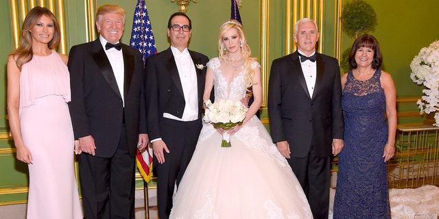 From left to right, first lady Melania Trump, President Donald Trump, Secretary of the Treasury Steven Mnuchin, Louise Linton, Vice President Mke Pence and second lady Karen Pence pose at the wedding of Mnuchin and Linton on June 24, 2017.