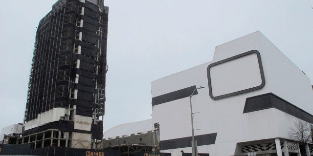 This Feb. 16, 2021 photo shows the former Trump Plaza casino in Atlantic City, N.J. on the day before its main tower, left, was to be imploded. The casino built by former President Donald Trump was once the playground of the rich and famous, but fell into disrepair after shutting down in 2014. (AP Photo/Wayne Parry)