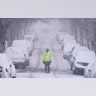 A traffic officer patrols a lightly trafficked street in Weehawken, N.J., Monday, Feb. 1, 2021. Snowfall is picking up in the Northeast as the region braced for a whopper of a storm that could dump well over a foot of snow in many areas, create blizzard-like conditions and cause travel problems for the next few days. (AP Photo/Seth Wenig)