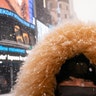Elinor Fukuda stops in Times Square during a snowstorm, Monday, Feb. 1, 2021, in the Manhattan borough of New York. (AP Photo/John Minchillo)