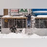 Workers clear snow away from an outdoor dining space erected due to COVID-19 restrictions, Monday, Feb. 1, 2021, in the Manhattan borough of New York. (AP Photo/John Minchillo)