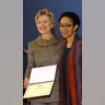 Sen. Hillary Rodham Clinton presents the award to Lorna C. Hill, founder and executive director of the Ujima Company Inc. In celebration of Black History Month, Clinton hosted her fifth annual African American Heritage Celebration in Harlem, New York, honoring several distinguished African American business and community leaders at the Harlem Children's Zone. Clinton joined with President and M.A.C. AIDS Fund Chairman John Demsey to dontate $25,000 to four New York Charities fighting AIDS in the African American community.