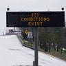 A truck drives past a highway sign Monday, Feb. 15, 2021, in Houston. A frigid blast of winter weather across the U.S. plunged Texas into an unusually icy emergency Monday that knocked out power to more than 2 million people and shut down grocery stores and dangerously snowy roads.