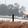 A wrecker crew works to remove a car from the median of Interstate55 in McComb, Miss., on Monday, Feb. 15, 2021. A winter storm dropping snow and ice also sent temperatures plunging across the southern Plains.