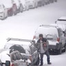 People clear snow off of cars Monday, Feb. 15, 2021, in St. Louis. Missouri is being hit by a winter storm bringing snow and brutally cold temperatures.