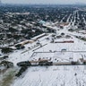 A Home Depot parking lot is covered in snow in the Westbury neighborhood, Monday, Feb. 15, 2021, in Houston. A winter storm making its way from the southern Plains to the Northeast is affecting air travel.