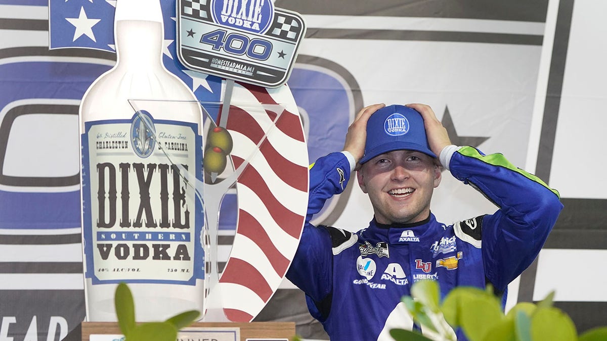 William Byron adjusts his cap as he celebrates after winning a NASCAR Cup Series auto race, Sunday, Feb. 28, 2021, in Homestead, Fla. (AP Photo/Wilfredo Lee)