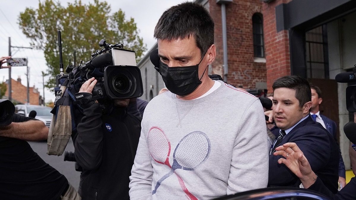Richard Pusey, the driver of a Porsche who allegedly fled the scene of a truck crash on Melbourne's Eastern Freeway which killed four police officers, is taken away from his Fitzroy property by police in Melbourne, Thursday, April 23, 2020. (AAP Image/Michael Dodge)