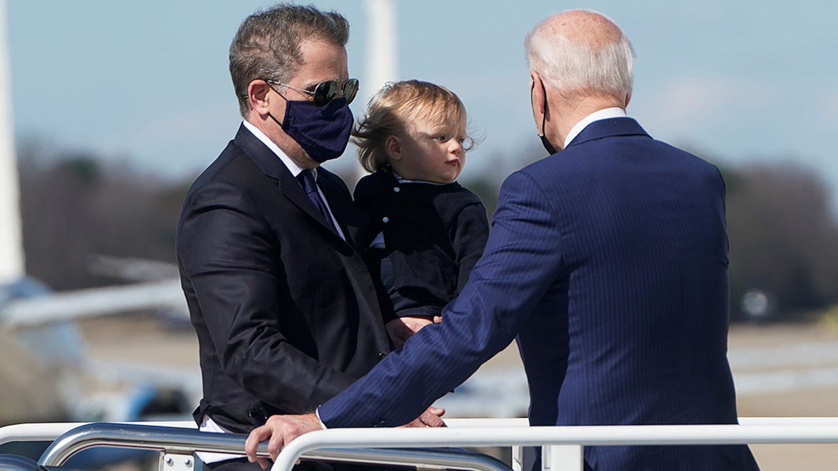 President Joe Biden assists his son Hunter Biden and grandson Beau while boarding Air Force One at Joint Base Andrews, Maryland, on March 26, 2021. (REUTERS/Joshua Roberts)