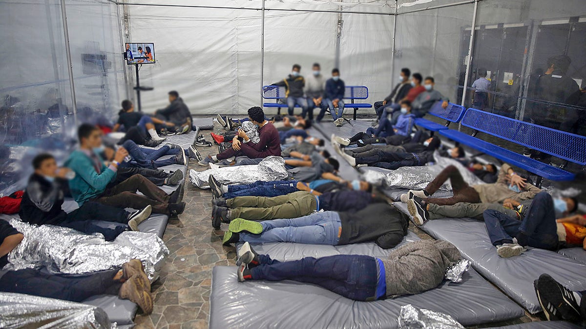 Young children lie inside a pod at the Donna Department of Homeland Security holding facility, the main detention center for unaccompanied children in the Rio Grande Valley run by U.S. Customs and Border Protection, in Donna, Texas.
