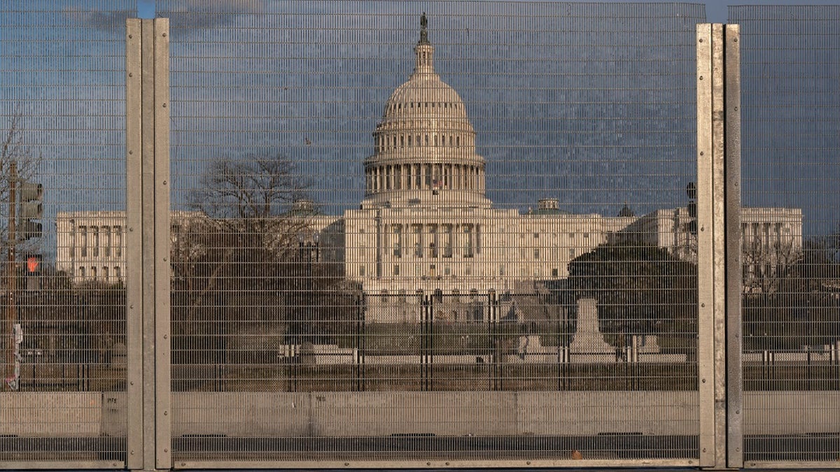 A section of fencing blocking the Capitol grounds is seen at sunset, on March 1 along a section of 3rd St that has had razor wire temporarily removed in Washington. remove portions of perimeter fencing erected around the Capitol (AP Photo/Jacquelyn Martin)