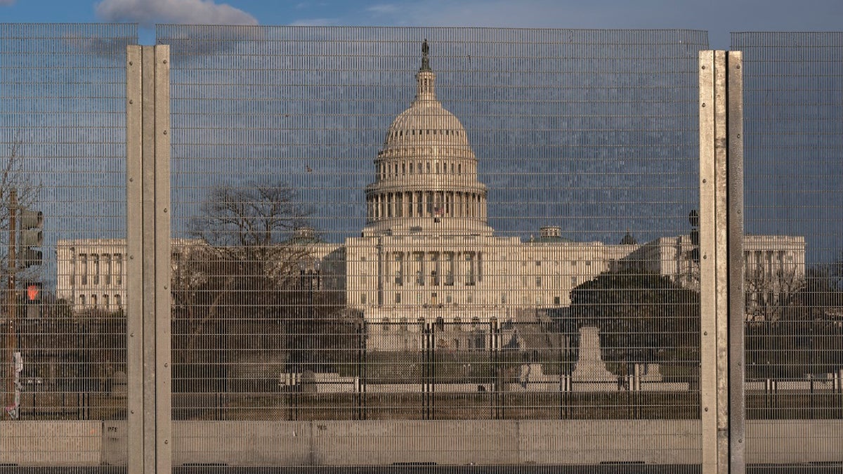 A section of fencing blocking the Capitol grounds is seen at sunset, on March 1 along a section of 3rd St that has had razor wire temporarily removed in Washington. remove portions of perimeter fencing erected around the Capitol (AP Photo/Jacquelyn Martin)