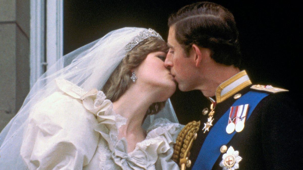 In this July 29, 1981 file photo, Britain's Prince Charles kisses his bride, the former Diana Spencer, on the balcony of Buckingham Palace in London, after their wedding.