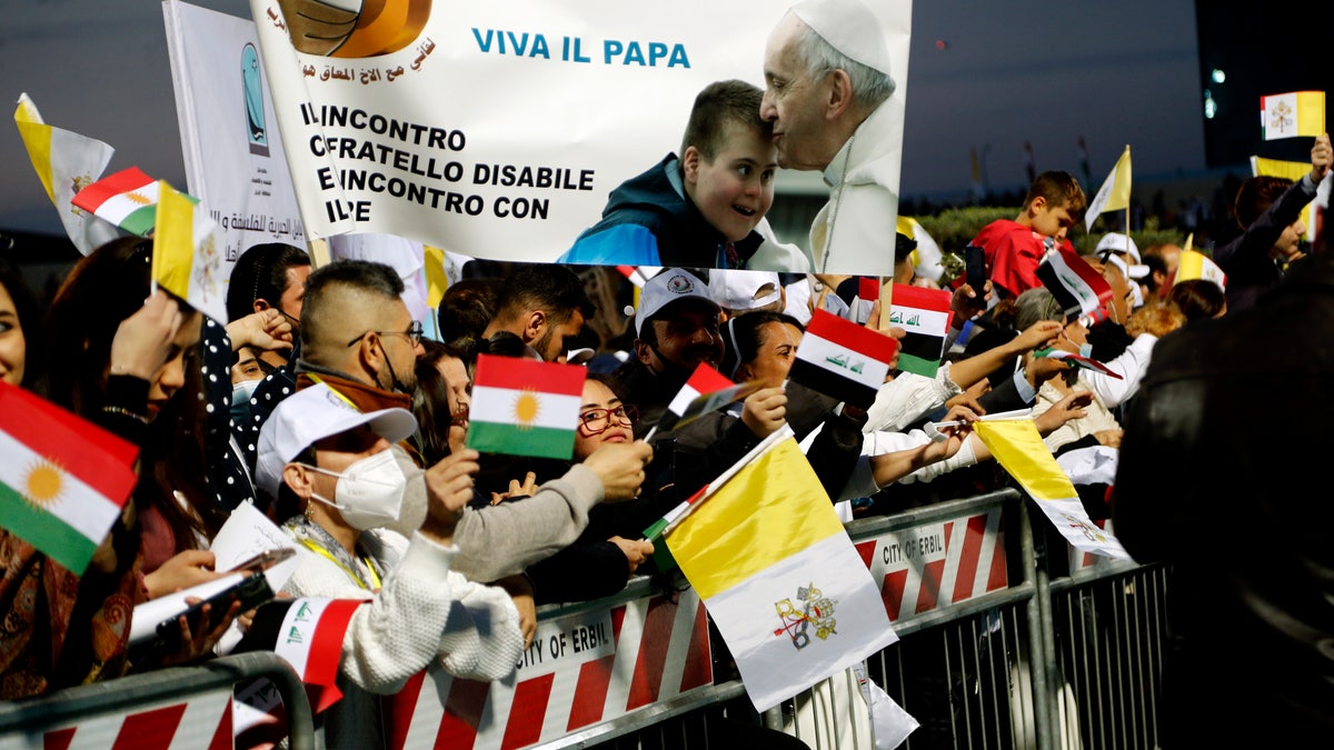 Iraqi Christians say goodbye to Pope Francis after an open air Mass at a stadium in Irbil, Iraq, Sunday, March 7, 2021. Thousands of people filled the sports stadium in the northern city of Irbil for Pope Francis' final event in his visit to Iraq: an open-air Mass featuring a statue of the Virgin Mary that was restored after Islamic militants chopped of the head and hands. (AP Photo/Hadi Mizban)