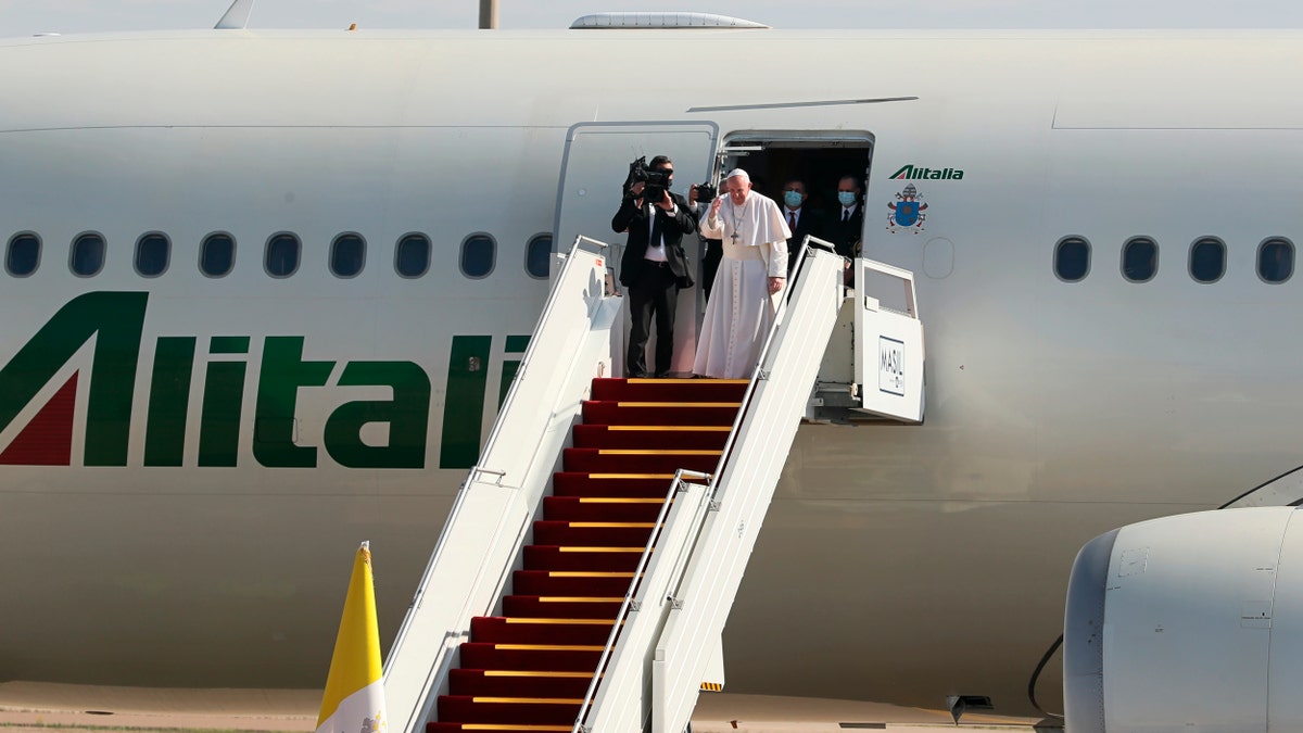 Pope Francis boards a plane upon concluding his visit to Iraq at Baghdad airport, Iraq, Monday, March 8, 2021. (AP Photo/Khalid Mohammed)