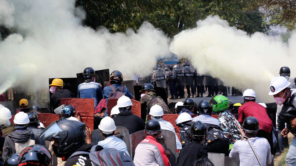 Anti-coup protesters discharge fire extinguishers to counter the impact of the tear gas fired by police during a demonstration in Naypyitaw, Burma, Monday, March 8, 2021. (AP Photo)