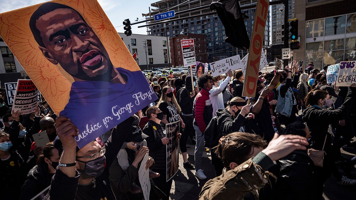 Protesters march on the first day of the Derek Chauvin trial Monday, March 8, 2021 in Minneapolis, Minn. Chauvin is the former Minneapolis police officer charged in the death of George Floyd. (Richard Tsong-Taatarii/Star Tribune via AP)