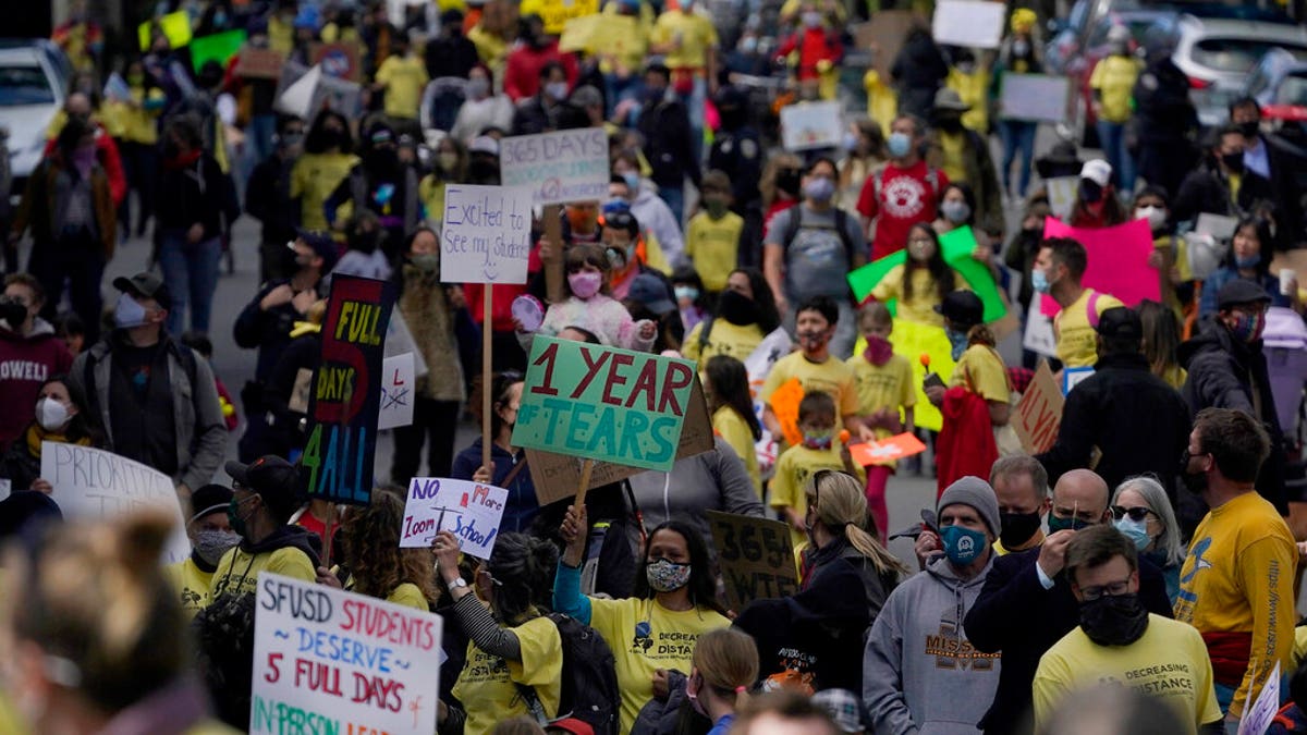 Parents, students, teachers and supporters march during a rally for San Francisco public schools to reopen during the coronavirus pandemic in San Francisco, Saturday, March 13, 2021. 