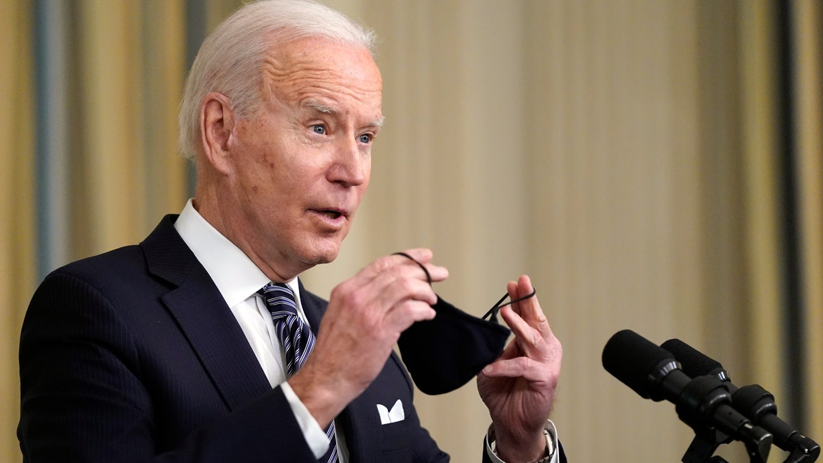 President Biden puts his face mask on after speaking about the COVID-19 relief package in the State Dining Room of the White House, Monday, March 15, 2021, in Washington. (AP Photo/Patrick Semansky)