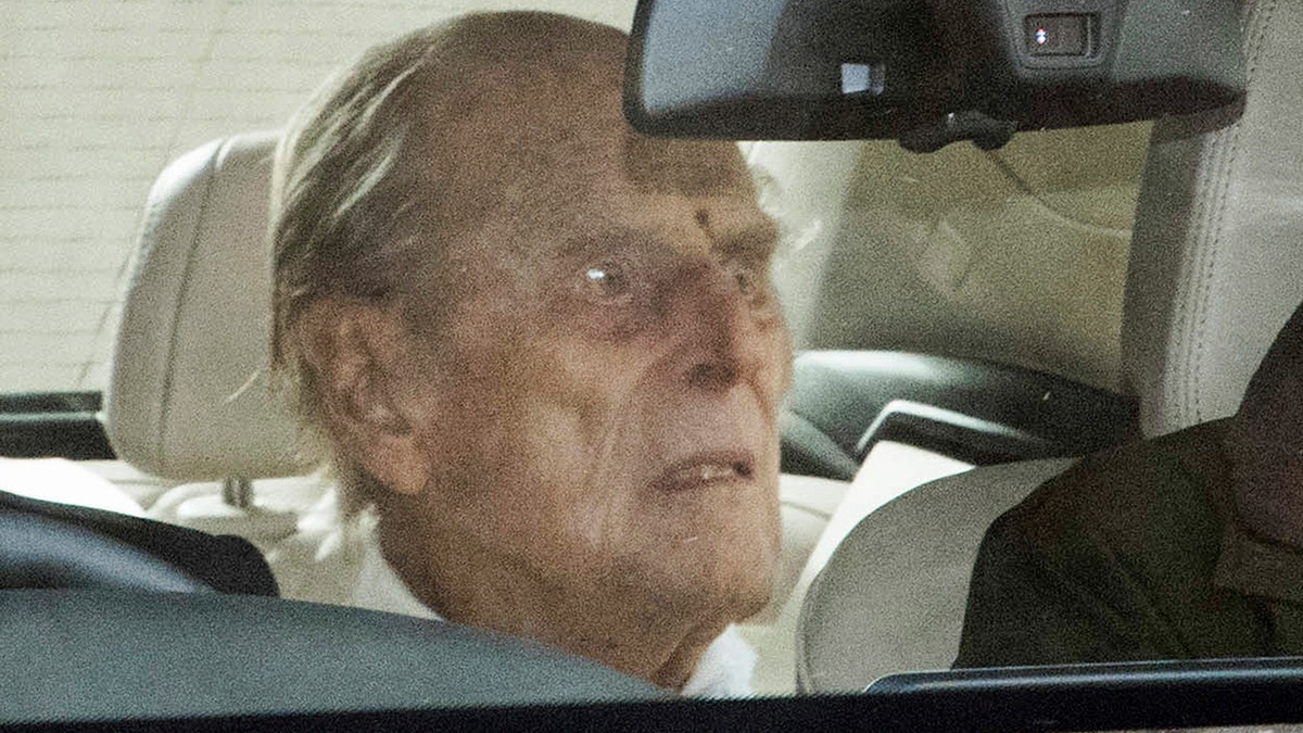 Britain's Prince Philip as he leaves the King Edward VII hospital in the back of a car in London, Tuesday, March 16, 2021. The 99-year-old husband of Queen Elizabeth II has been hospitalized after a heart procedure.