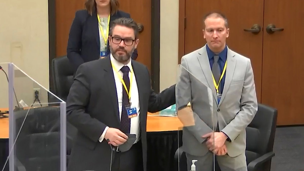 In this screengrab from video, defense attorney Eric Nelson, left, defendant and former Minneapolis police officer Derek Chauvin, right, introduce themselves to jurors as Hennepin County Judge Peter Cahill presides over jury selection in the trial of Chauvin on Wednesday. On Thursday, a 12th juror was seated. (Court TV, via AP, Pool)
