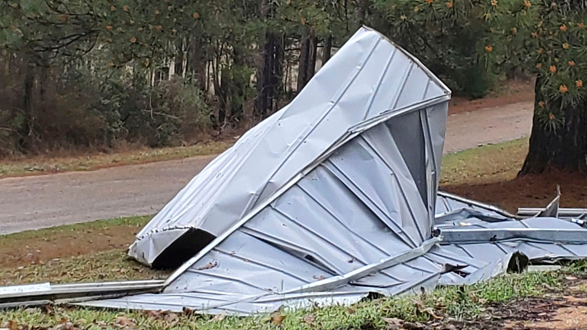 This tin roof was blown off a building by severe winds in the Woolworth community in northeast Lincoln County, Miss., Wednesday, March 17, 2021. Forecasters believe more severe weather is expected Wednesday with the potential for massive tornadoes, downpours and hail the size of tennis balls. (Brett Campbell/The Daily Leader)