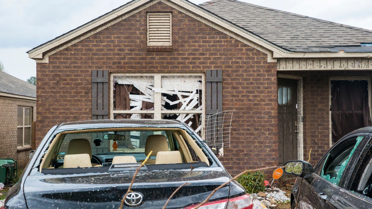 Homes and cars on Waterbury Drive were heavily damaged from severe weather, Wednesday, March 17, 2021, in Moundville, Ala. Possible tornadoes knocked down trees, toppled power lines and damaged homes in rural Chilton County and the Alabama communities of Burnsville and Moundville, where power was out and trees blocked a main highway. (AP Photo/Vasha Hunt)