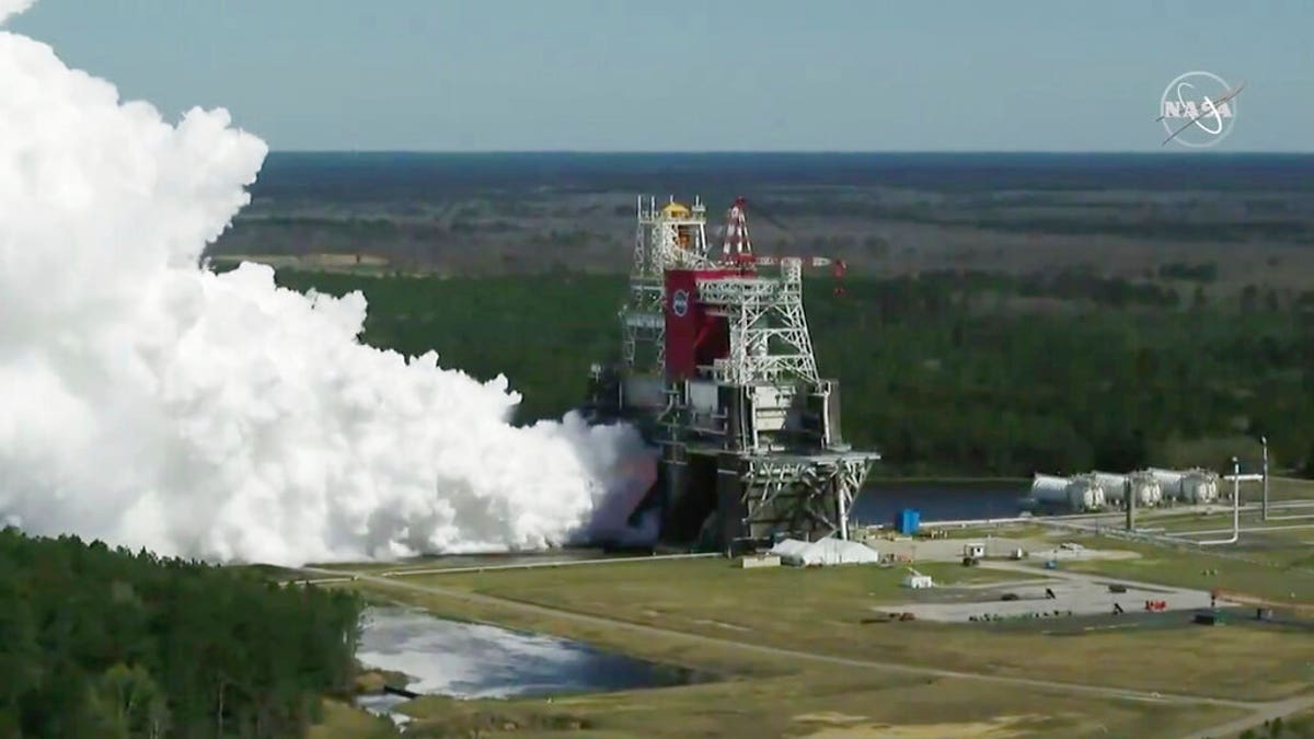 In this image from video made available by NASA, the core stage of the Space Launch System, NASA’s planned moon rocket, is tested at the Stennis Space Center near Bay St. Louis, Miss., on Thursday, Mar. 18, 2021. 