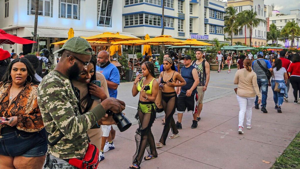 Despite the coronavirus, spring breakers return to South Beach and walk along Ocean Drive that is closed to traffic on Thursday, March 12, 2021. 