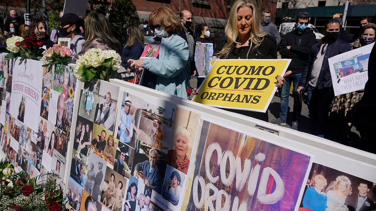 Families who had relatives that died from COVID-19 in nursing homes gather before the start of a news conference in New York, Sunday, March 21, 2021. The families gathered to grieve but want an investigation into and accountability from Gov. Andrew Cuomo. (AP Photo/Seth Wenig)