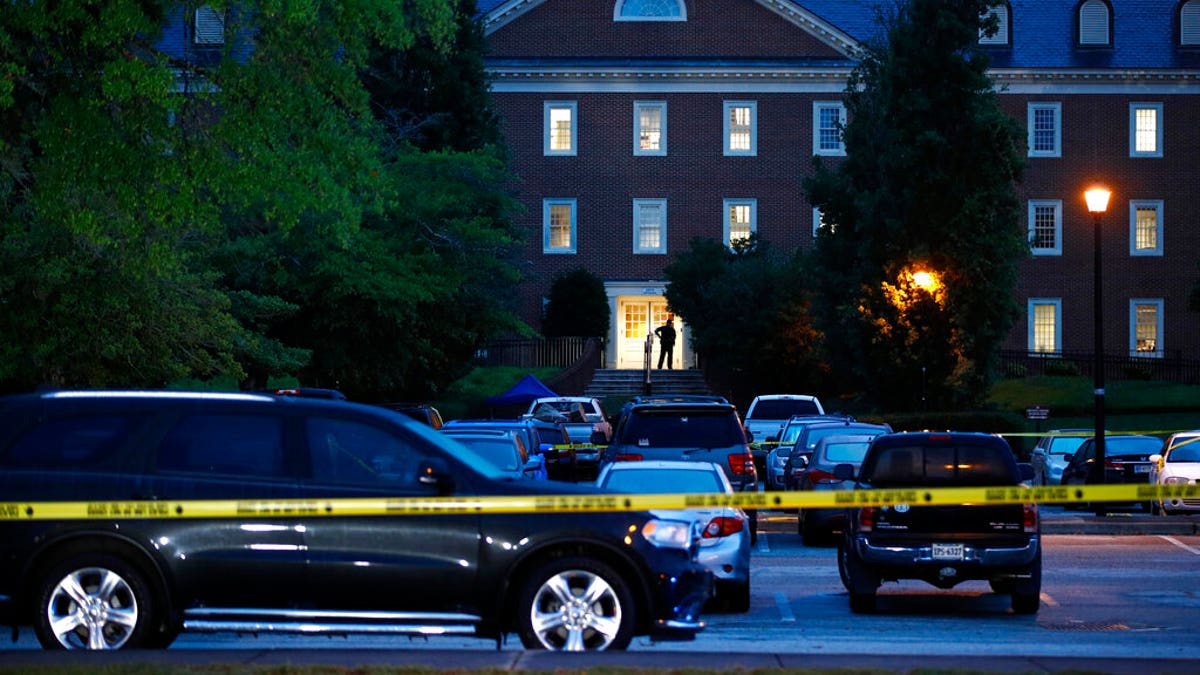 In this Saturday, June 1, 2019 file photo, a law enforcement official stands at an entrance to a municipal building that was the scene of a shooting in Virginia Beach. 